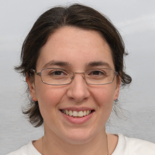 Joyful white adult female with medium  brown hair and brown eyes