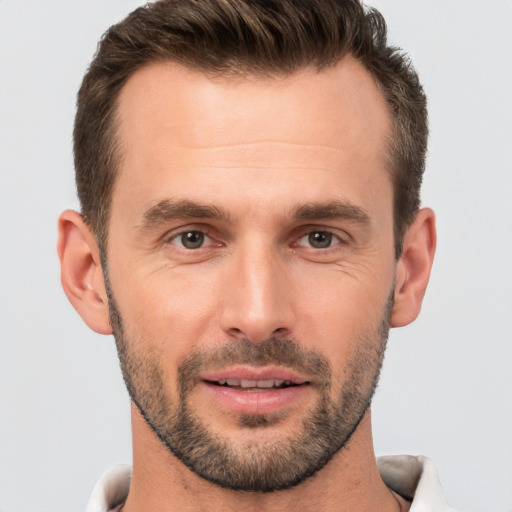 Joyful white adult male with short  brown hair and brown eyes