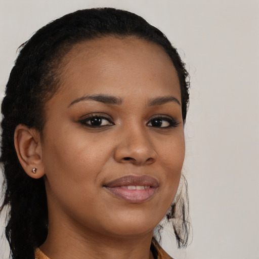 Joyful black young-adult female with long  brown hair and brown eyes