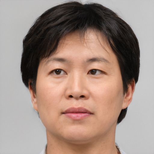 Neutral asian adult female with short  brown hair and brown eyes
