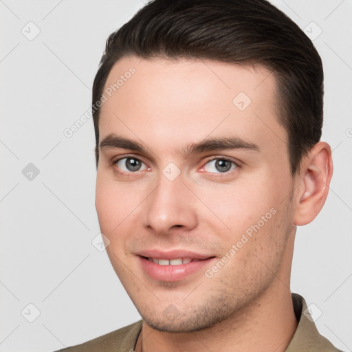 Joyful white young-adult male with short  brown hair and brown eyes