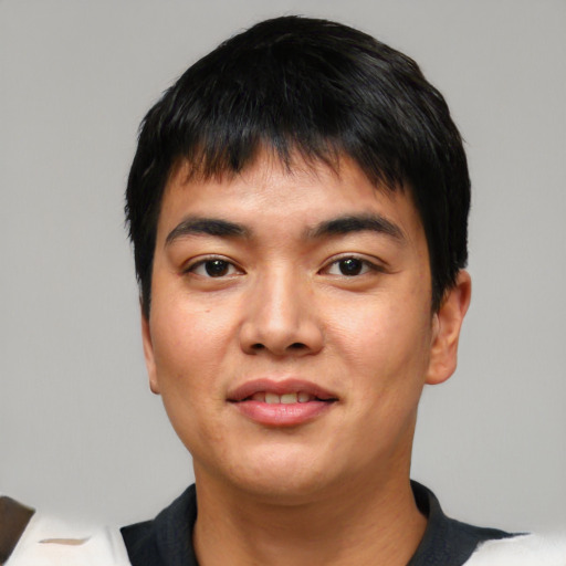 Joyful asian young-adult male with short  black hair and brown eyes
