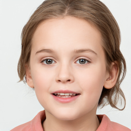 Joyful white child female with medium  brown hair and grey eyes