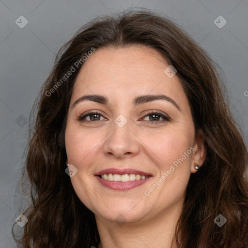 Joyful white adult female with long  brown hair and brown eyes