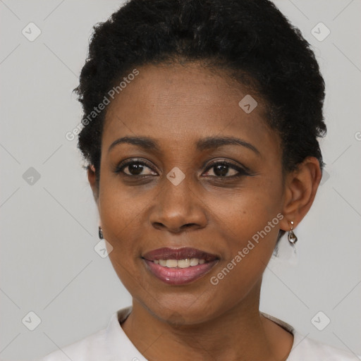 Joyful black young-adult female with short  black hair and brown eyes