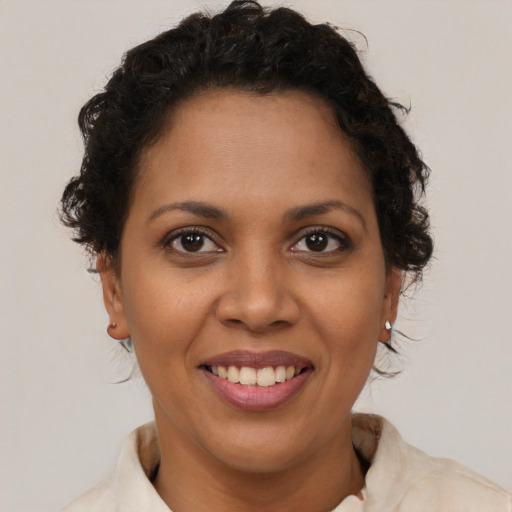 Joyful latino young-adult female with short  brown hair and brown eyes