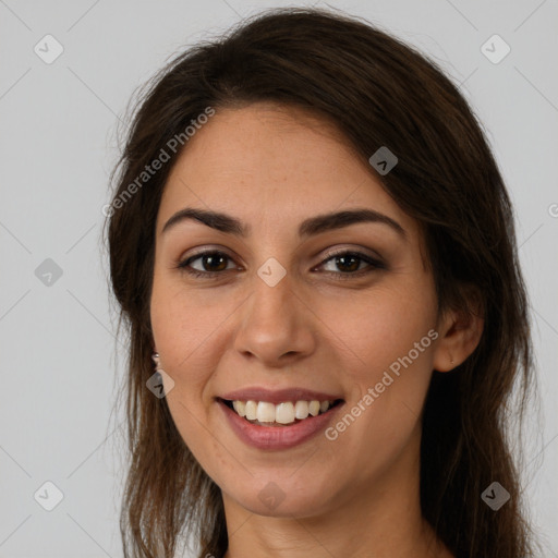 Joyful white young-adult female with long  brown hair and brown eyes