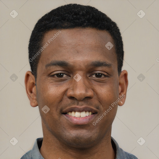 Joyful black young-adult male with short  black hair and brown eyes