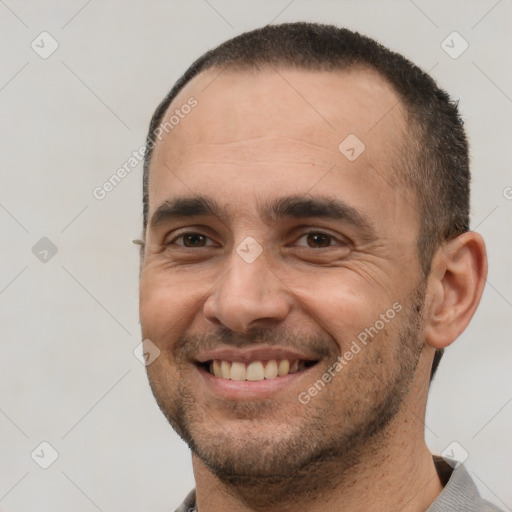 Joyful white adult male with short  black hair and brown eyes