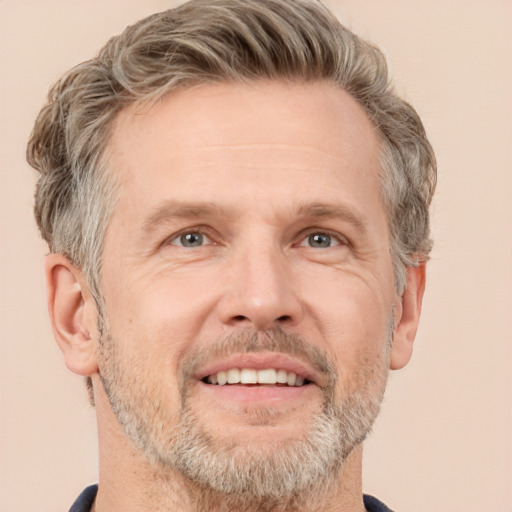 Joyful white middle-aged male with short  brown hair and grey eyes