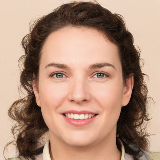 Joyful white young-adult female with medium  brown hair and green eyes