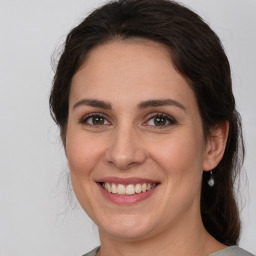 Joyful white young-adult female with medium  brown hair and brown eyes