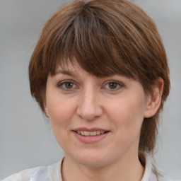 Joyful white adult female with medium  brown hair and brown eyes