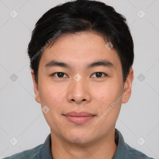 Joyful asian young-adult male with short  brown hair and brown eyes