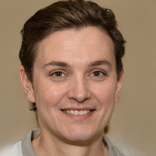 Joyful white adult female with short  brown hair and grey eyes