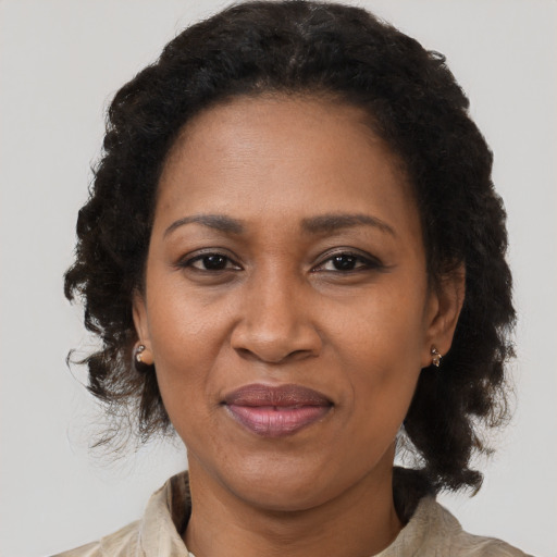 Joyful black adult female with medium  black hair and brown eyes