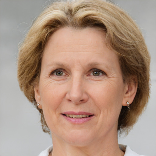 Joyful white middle-aged female with medium  brown hair and grey eyes