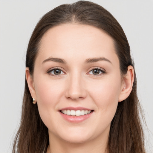 Joyful white young-adult female with long  brown hair and grey eyes