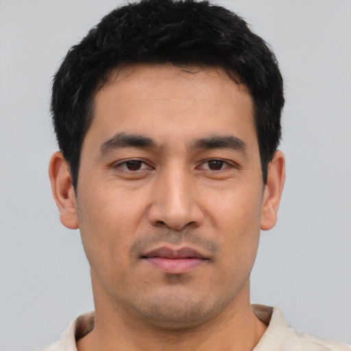 Joyful asian young-adult male with short  black hair and brown eyes