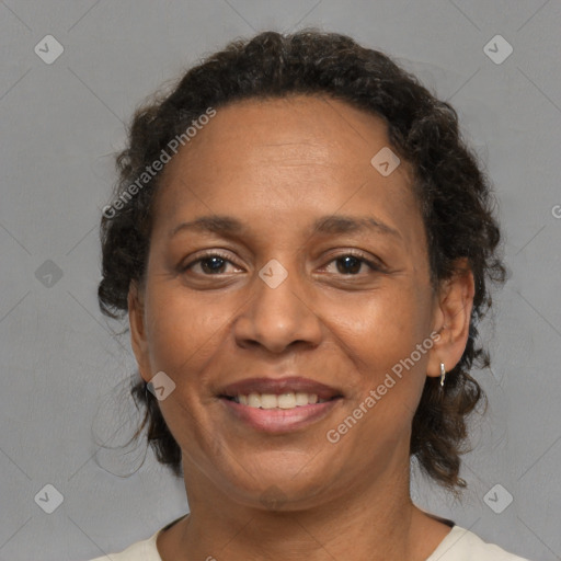 Joyful black adult female with medium  brown hair and brown eyes