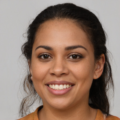 Joyful latino young-adult female with medium  brown hair and brown eyes