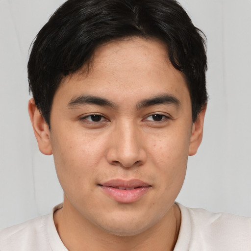 Joyful asian young-adult male with short  brown hair and brown eyes