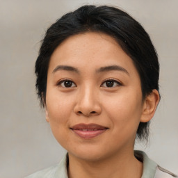 Joyful asian young-adult female with medium  black hair and brown eyes