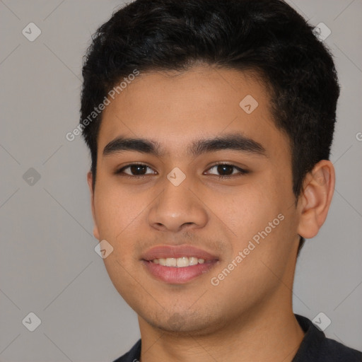 Joyful latino young-adult male with short  black hair and brown eyes