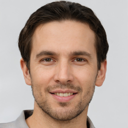 Joyful white young-adult male with short  brown hair and brown eyes