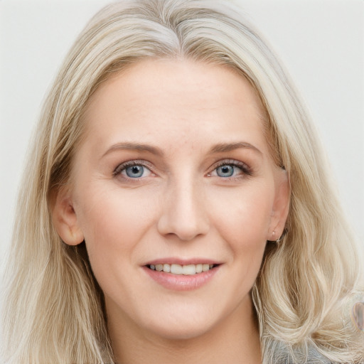 Joyful white young-adult female with long  brown hair and blue eyes