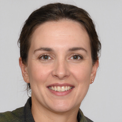 Joyful white adult female with medium  brown hair and grey eyes