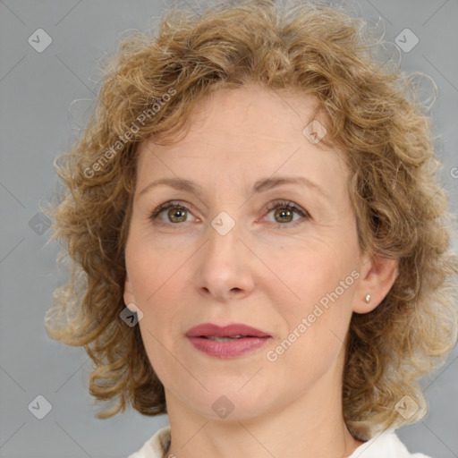 Joyful white adult female with medium  brown hair and blue eyes