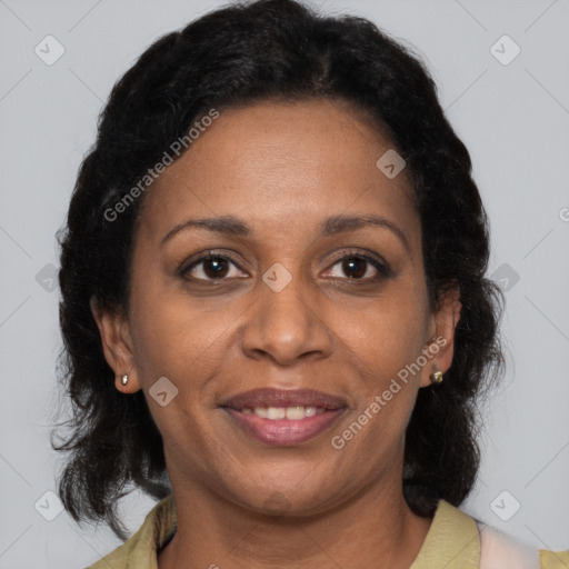Joyful black adult female with medium  brown hair and brown eyes