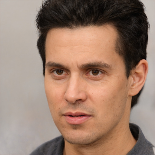 Joyful white adult male with short  brown hair and brown eyes