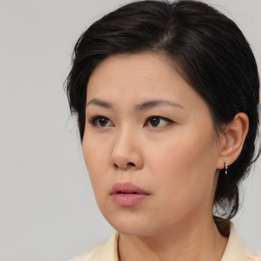 Neutral asian young-adult female with medium  brown hair and brown eyes