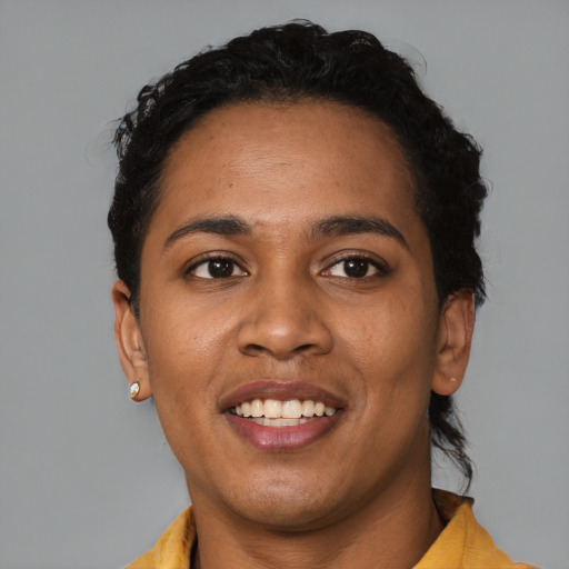 Joyful black young-adult female with short  black hair and brown eyes