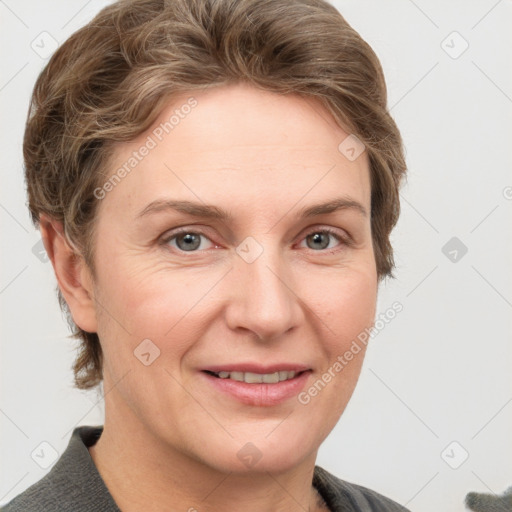 Joyful white adult female with short  brown hair and grey eyes