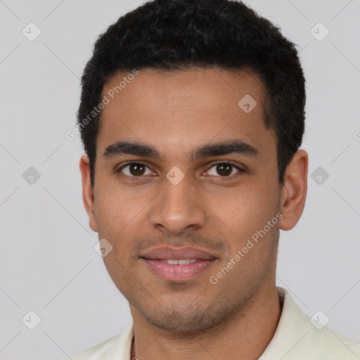 Joyful latino young-adult male with short  black hair and brown eyes