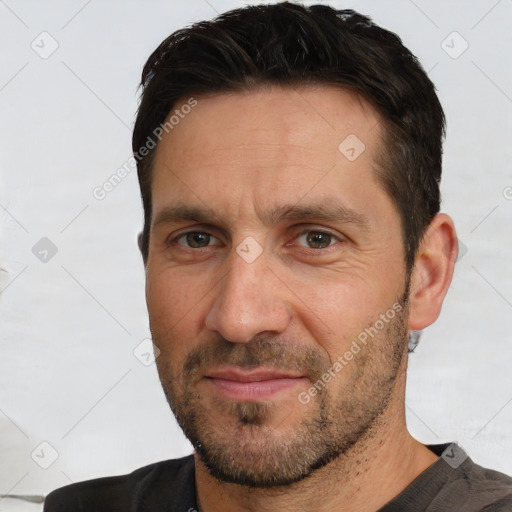 Joyful white adult male with short  brown hair and brown eyes