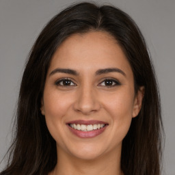 Joyful white young-adult female with long  brown hair and brown eyes