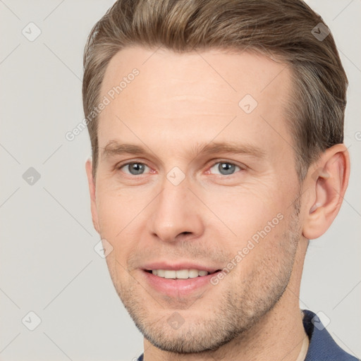 Joyful white adult male with short  brown hair and brown eyes