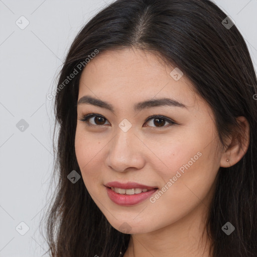 Joyful asian young-adult female with long  brown hair and brown eyes