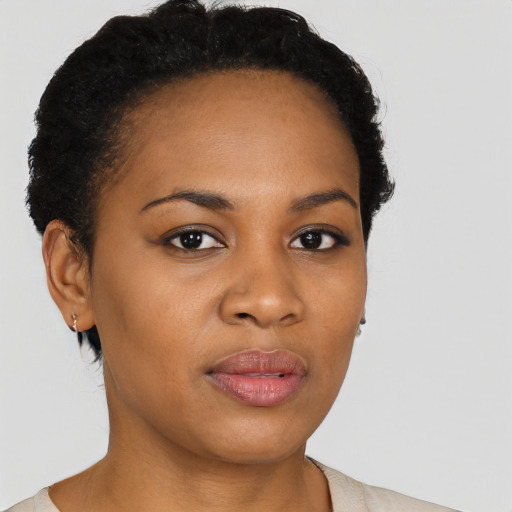 Joyful black young-adult female with short  black hair and brown eyes