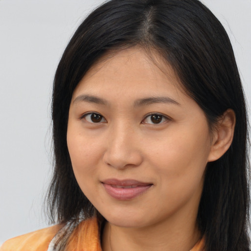 Joyful asian young-adult female with long  brown hair and brown eyes