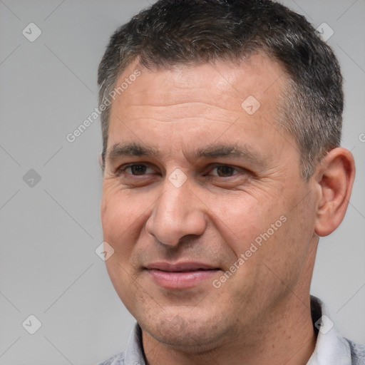 Joyful white adult male with short  brown hair and brown eyes