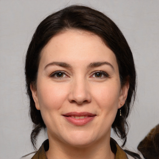 Joyful white young-adult female with medium  brown hair and brown eyes