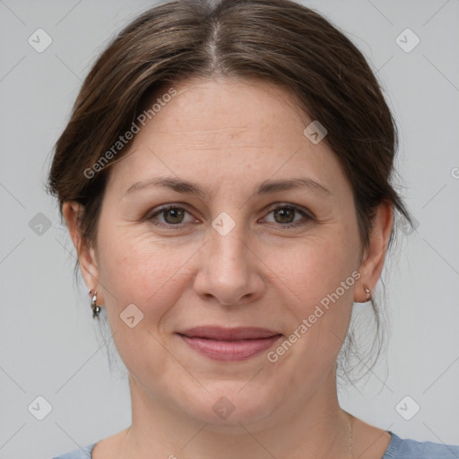 Joyful white adult female with medium  brown hair and grey eyes