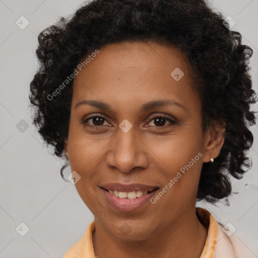 Joyful black adult female with short  brown hair and brown eyes