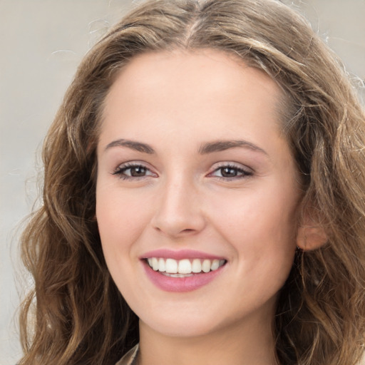 Joyful white young-adult female with long  brown hair and green eyes