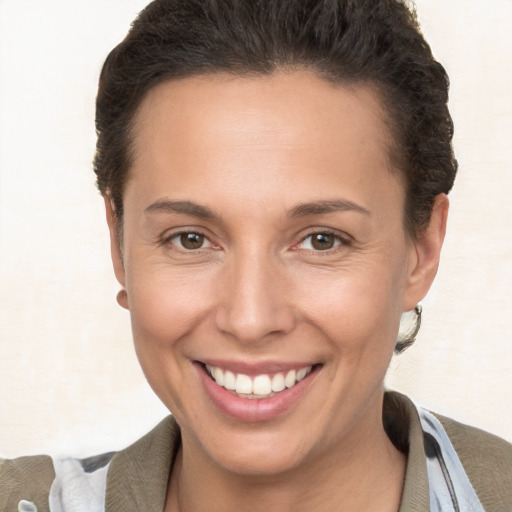 Joyful white young-adult female with short  brown hair and brown eyes